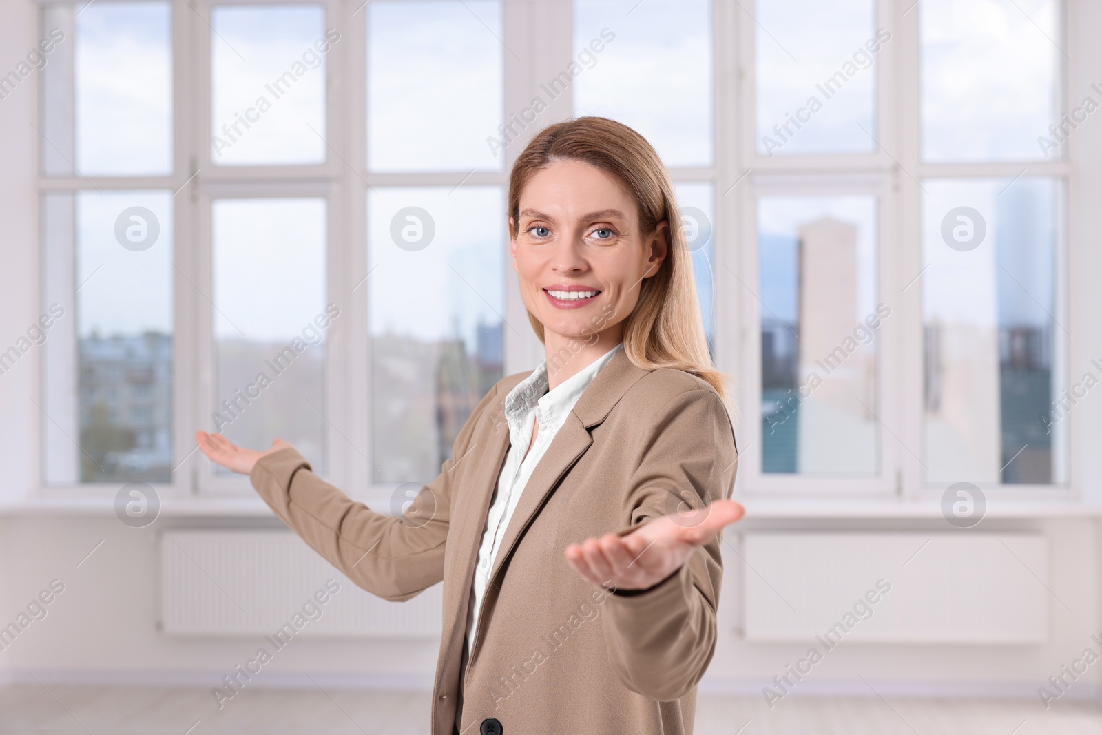 Photo of Happy real estate agent showing new apartment