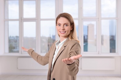 Happy real estate agent showing new apartment