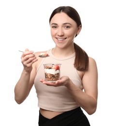 Happy woman eating tasty granola with fresh berries and yogurt on white background