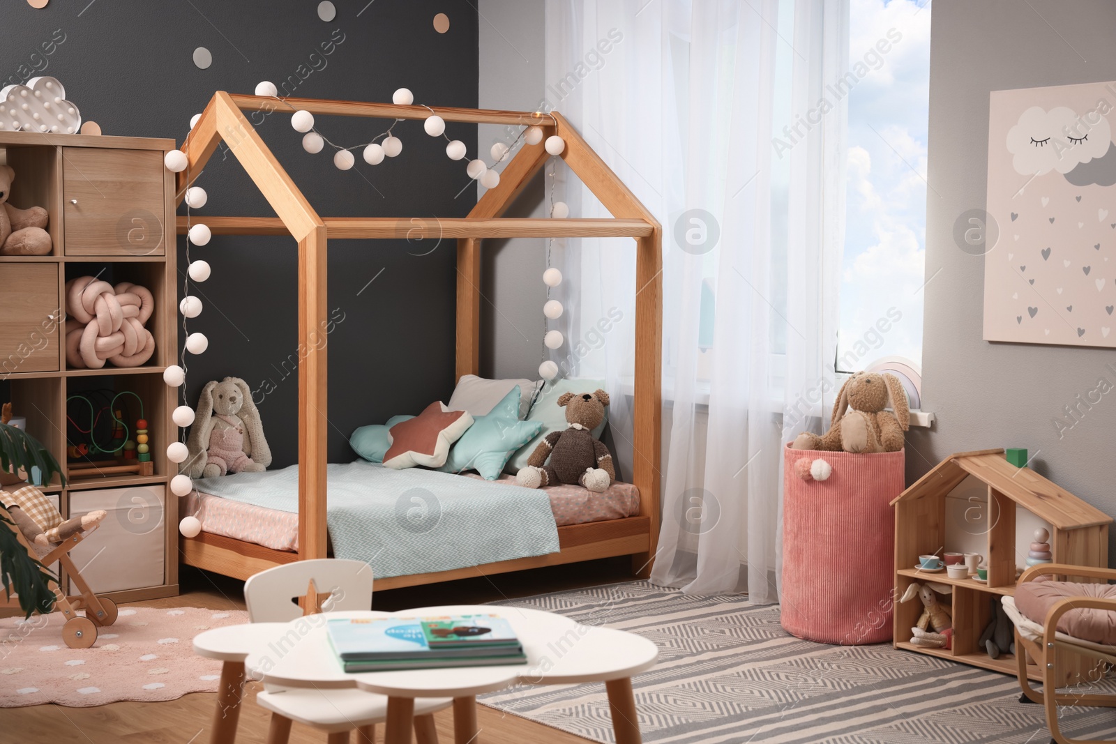 Photo of Comfortable house bed in child room. Stylish interior