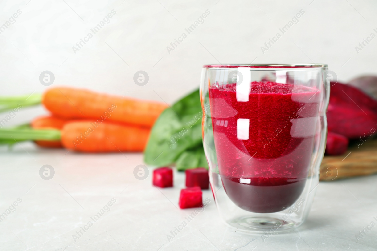 Photo of Glass of fresh beet juice on table