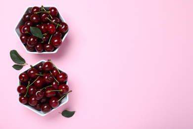 Photo of Sweet juicy cherries on pink background, flat lay. Space for text