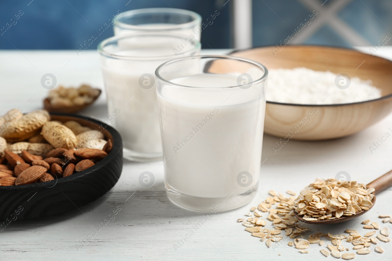 Photo of Glasses with different types of milk on wooden table