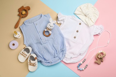 Flat lay composition with baby clothes and accessories on color background