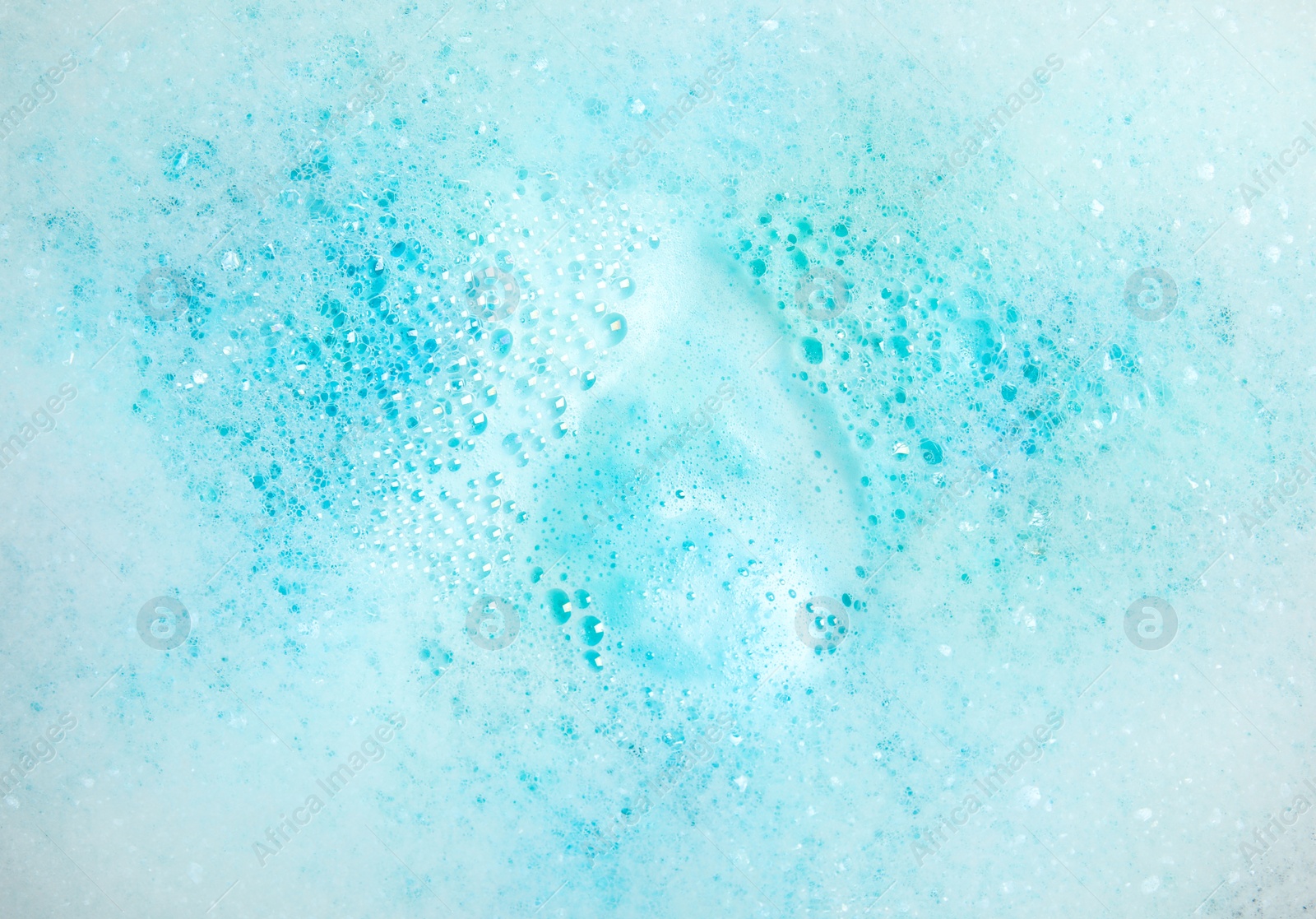Photo of View of foam after dissolving color bath bomb in water, closeup