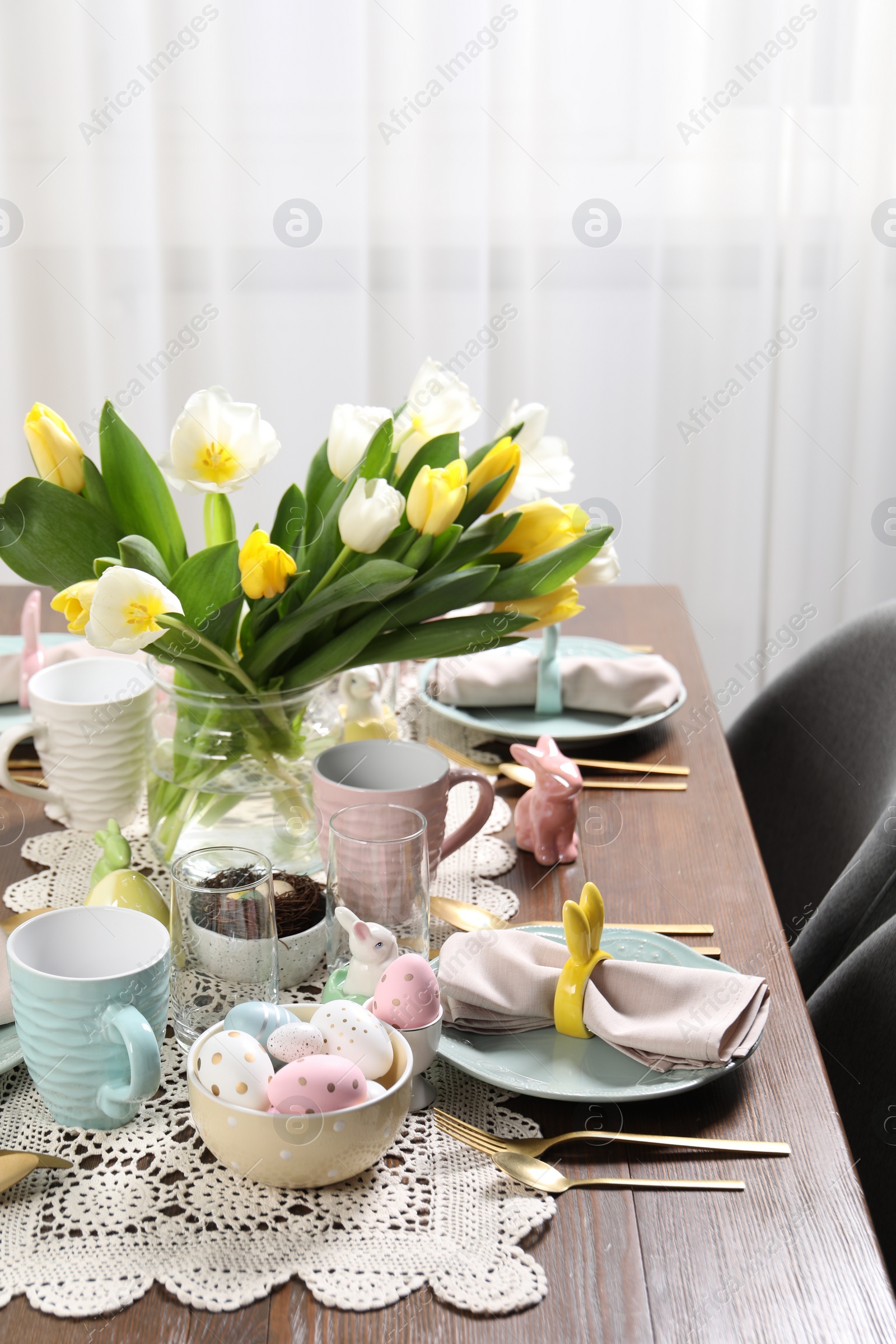 Photo of Festive table setting with beautiful flowers. Easter celebration