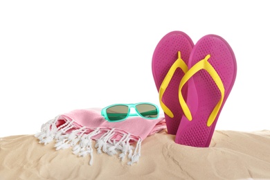 Photo of Sunglasses, flip flops and towel on sand against white background. Beach accessories