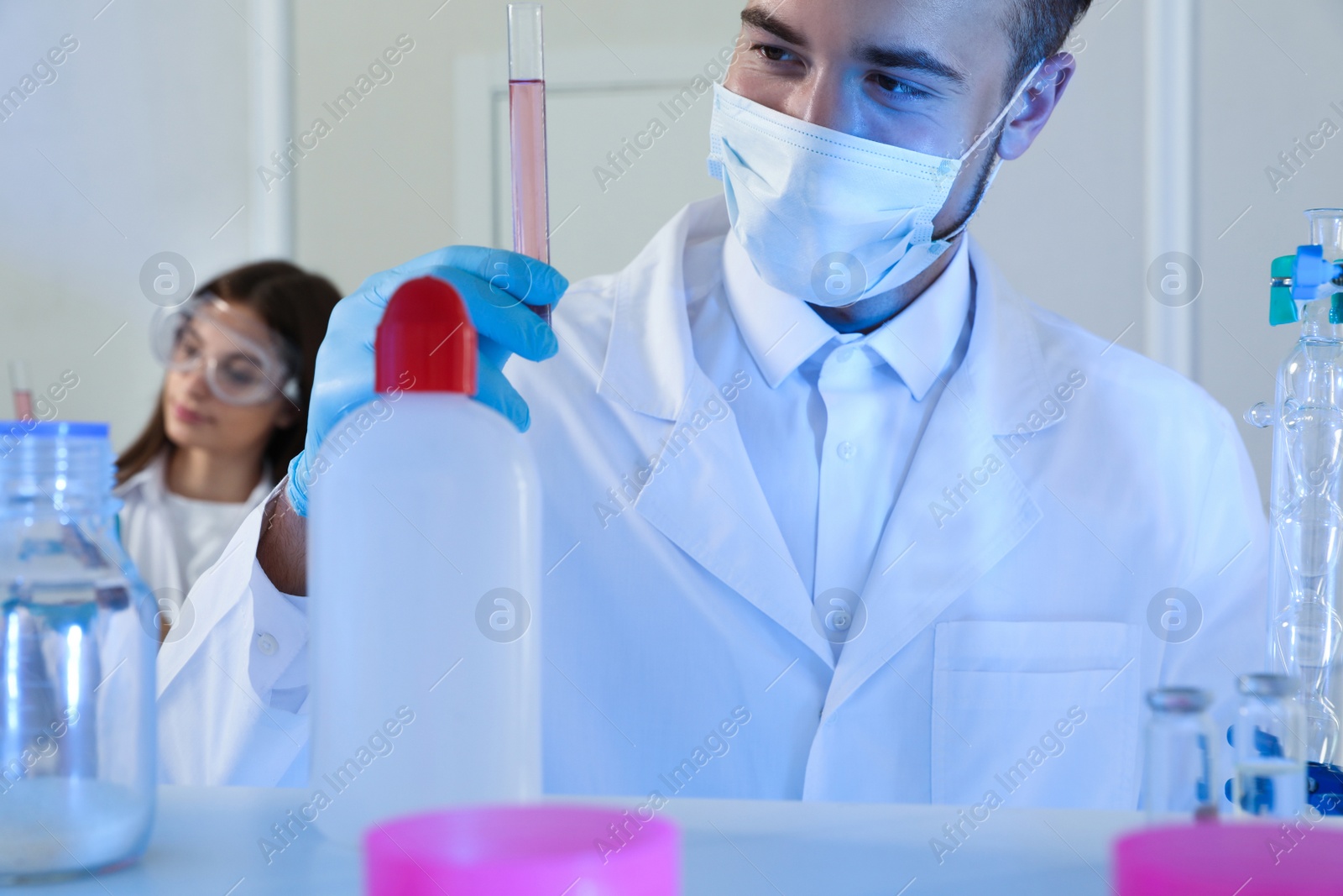 Photo of Scientist holding test tube with liquid indoors. Laboratory analysis