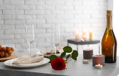 Photo of Romantic table setting with burning candles indoors