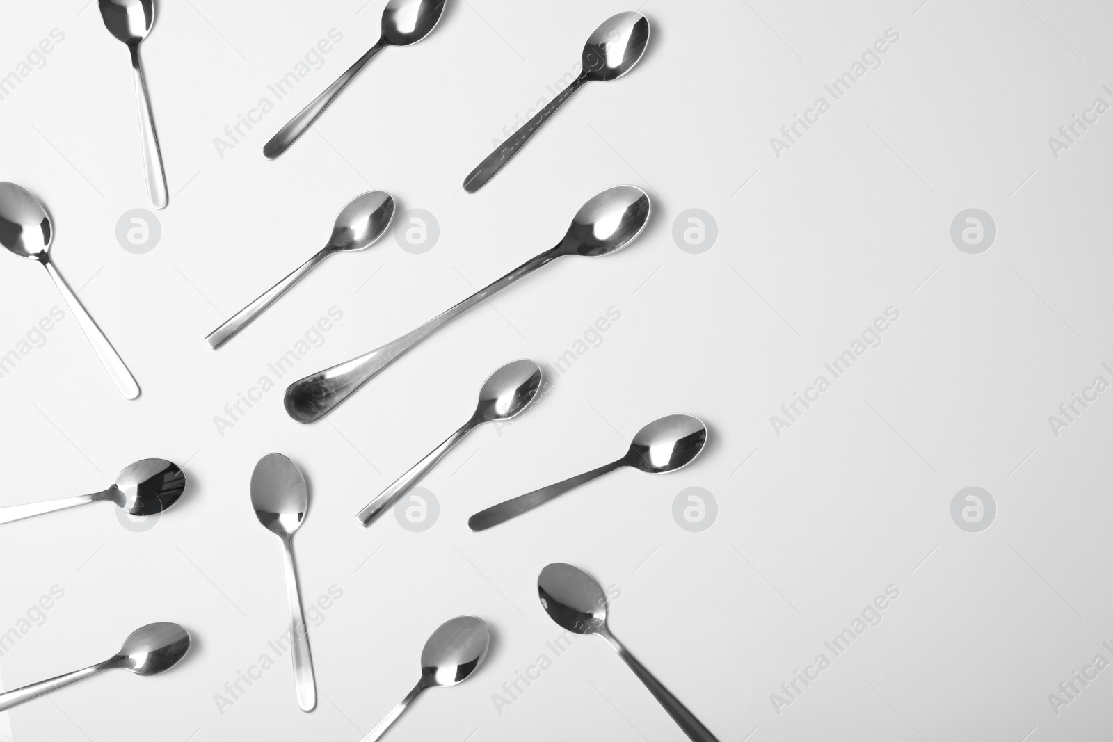 Photo of Set of new metal cutlery on white background, top view