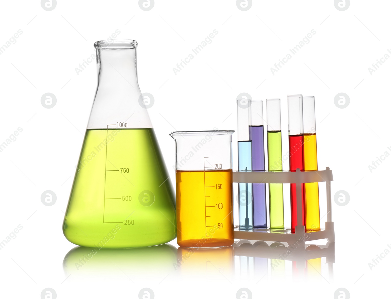 Photo of Set of lab glassware with color liquids isolated on white. Solution chemistry