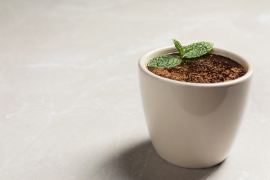 Photo of Cupdelicious hot chocolate with fresh mint on grey table, closeup. Space for text