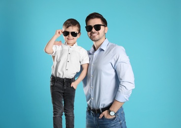 Photo of Portrait of dad and his son on color background