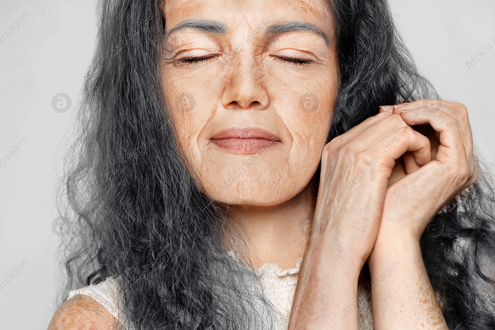 Image of Portrait of senior woman on light background