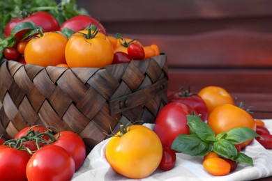 Different sorts of tomatoes on wooden bench