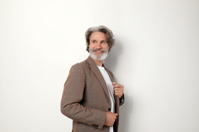 Portrait of handsome mature man on light background