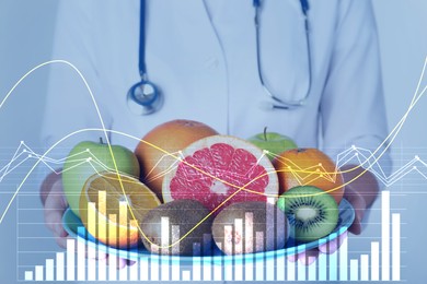 Image of Nutritionist holding plate with ripe fruits and illustration of charts. Healthy eating