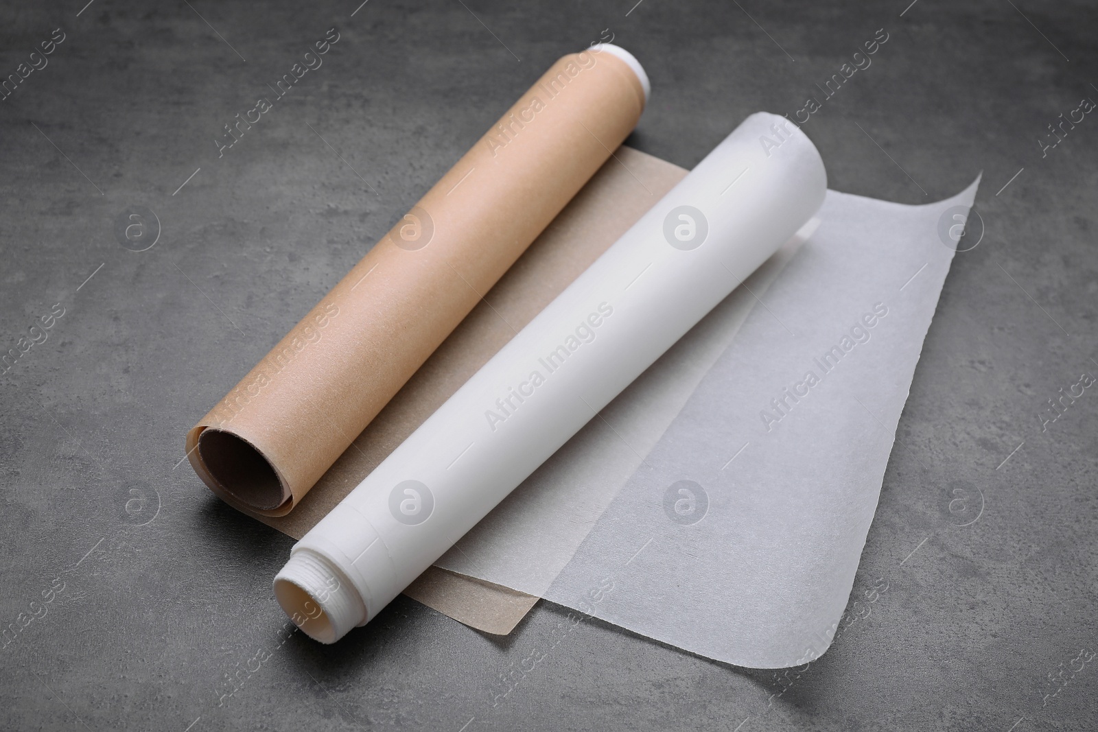 Photo of Rolls of baking paper on grey table