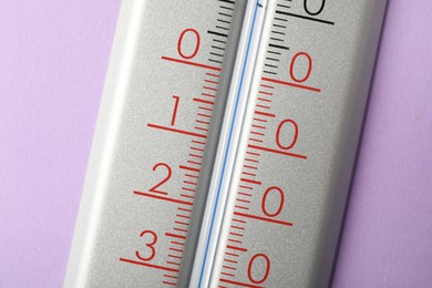 Modern weather thermometer on lilac background, closeup