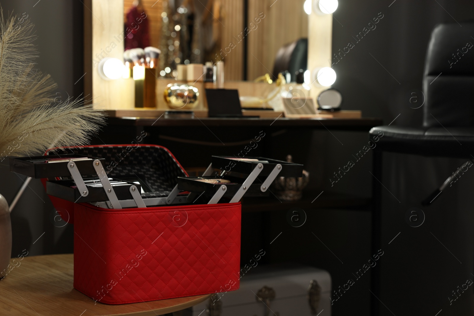 Photo of Beautician case with professional cosmetics in makeup room