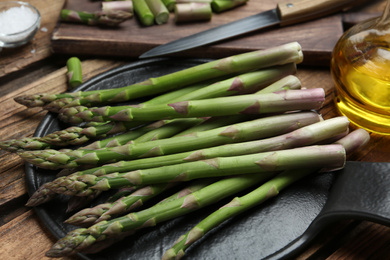 Raw green asparagus on slate board, closeup