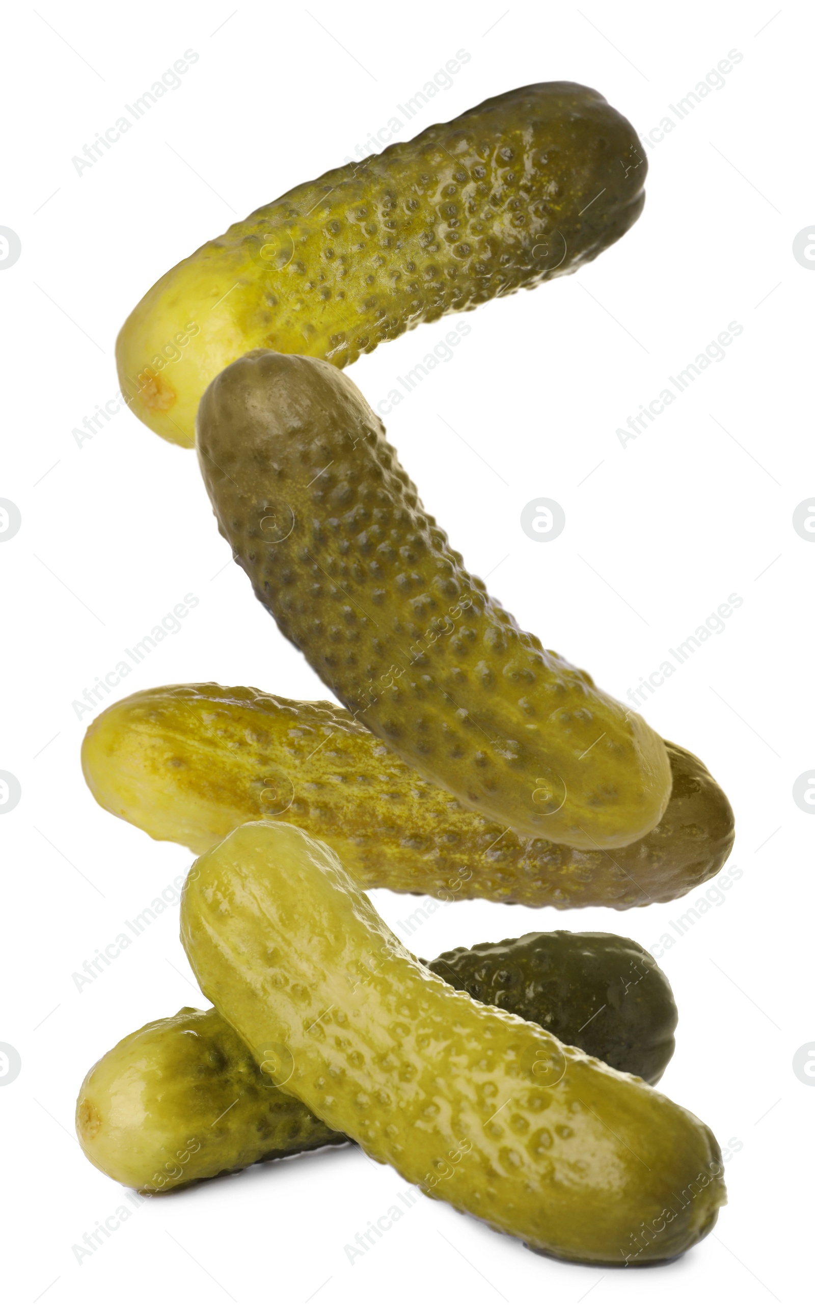 Image of Tasty pickled cucumbers falling on white background