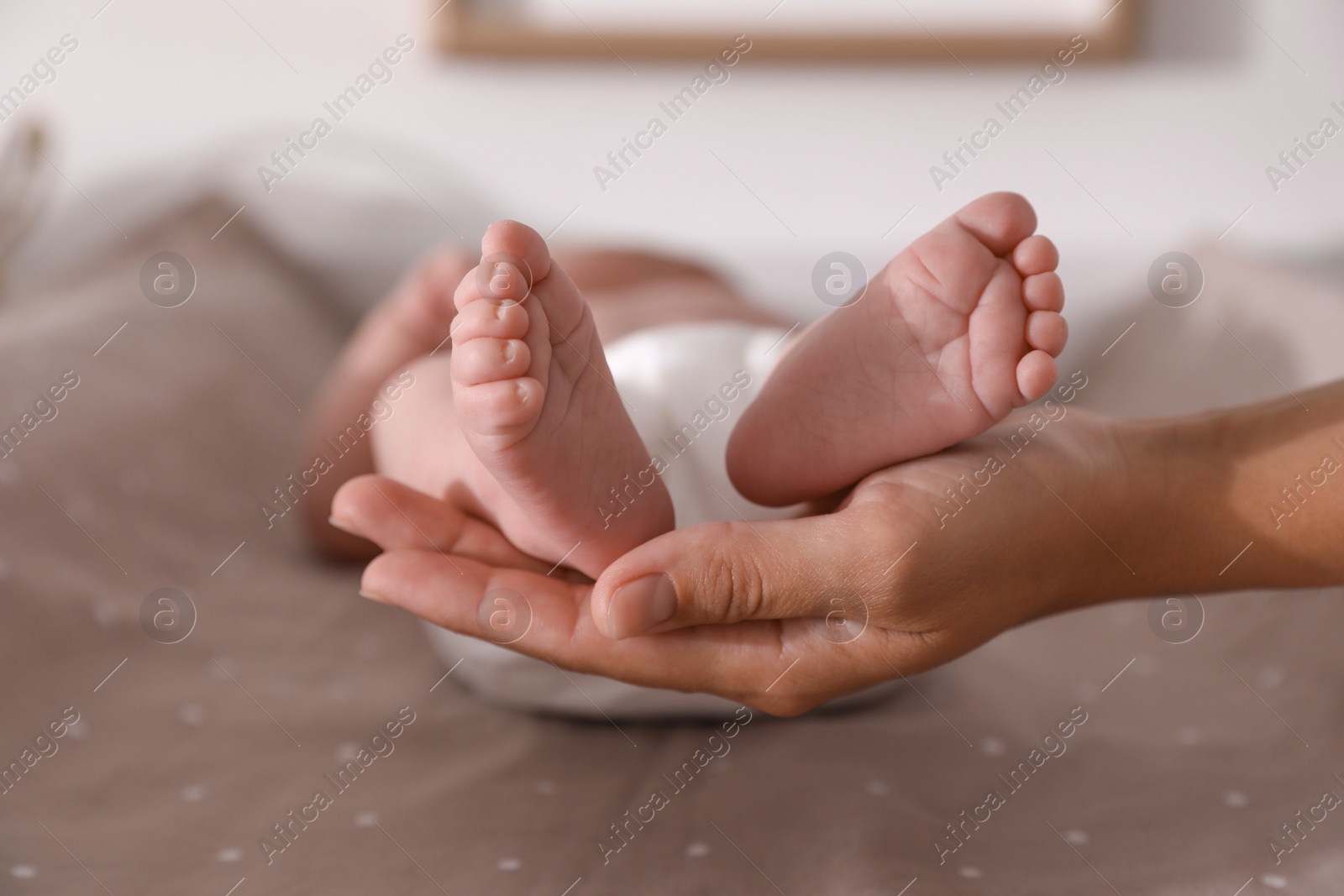 Photo of Mother and her little baby on bed, closeup