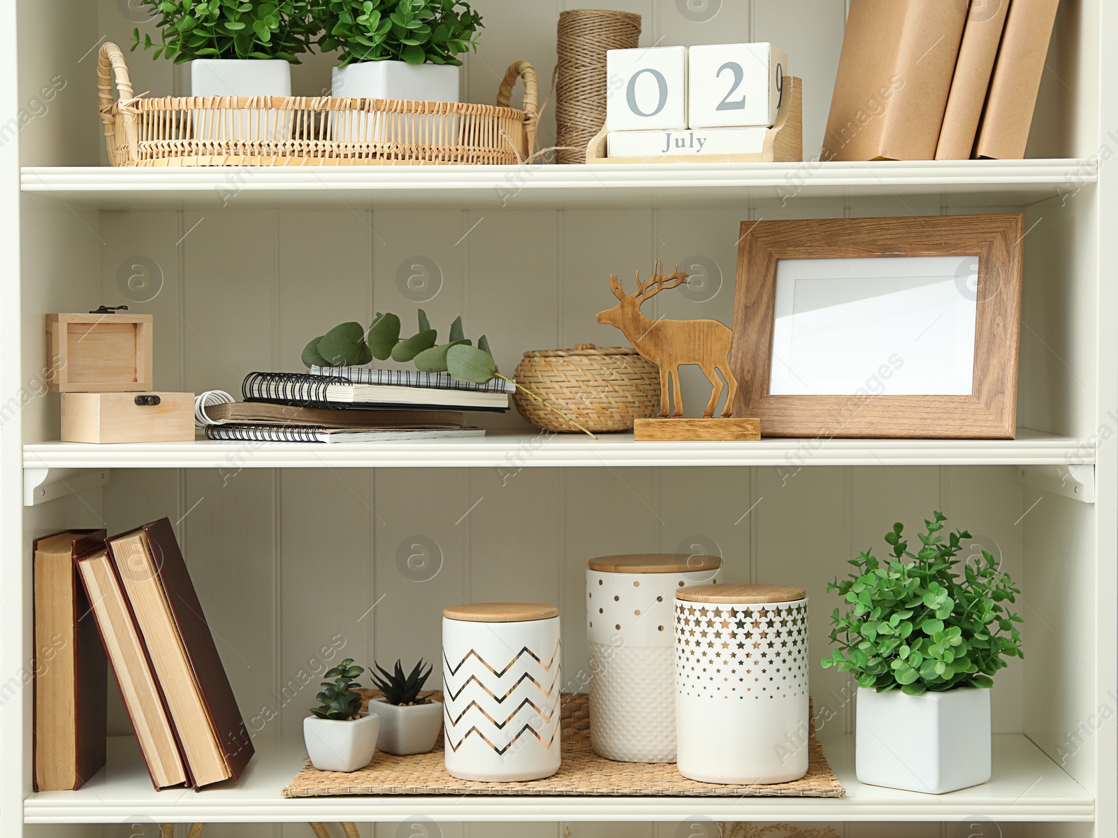 Photo of White shelving unit with different decorative elements