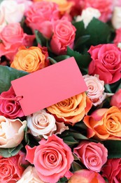 Photo of Bouquet of beautiful roses with blank card, top view