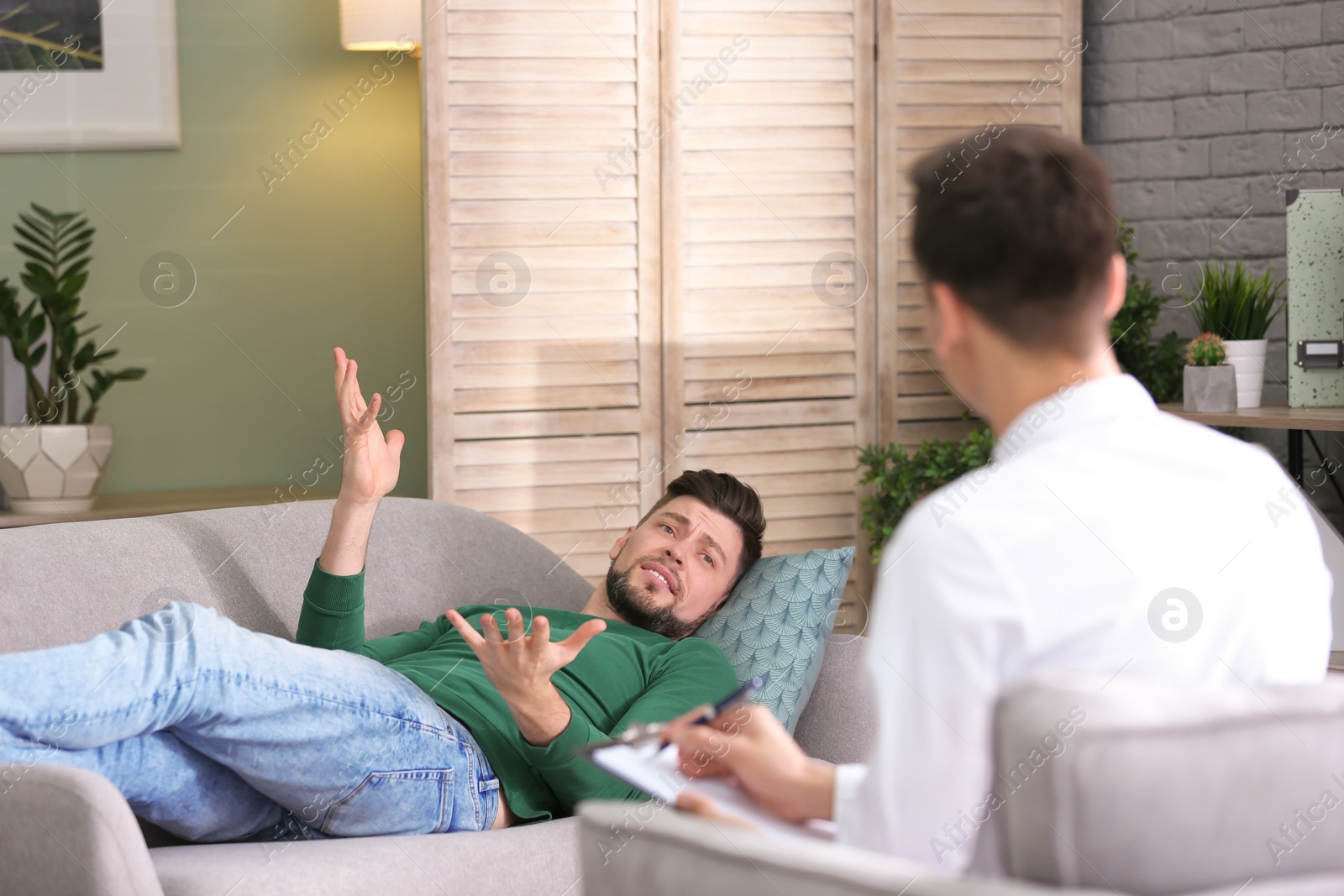 Photo of Male psychologist with client in office