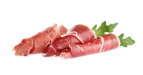 Slices of tasty prosciutto on white background