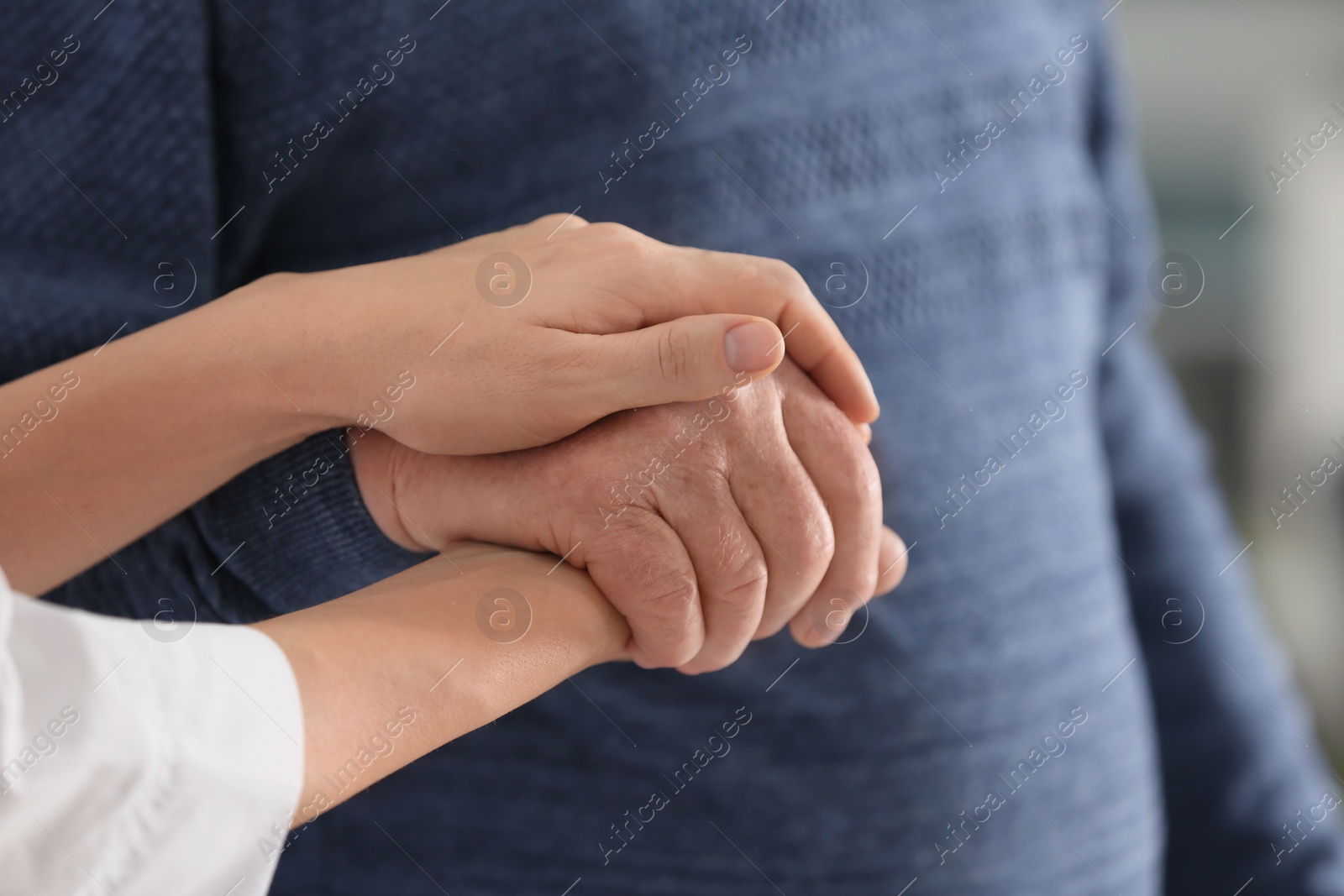 Photo of Elderly man with female caregiver, closeup view