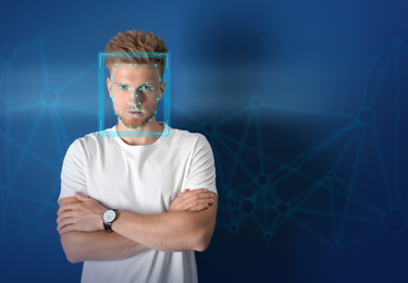 Image of Facial recognition system. Young man with scanner frame and digital biometric grid on blue background