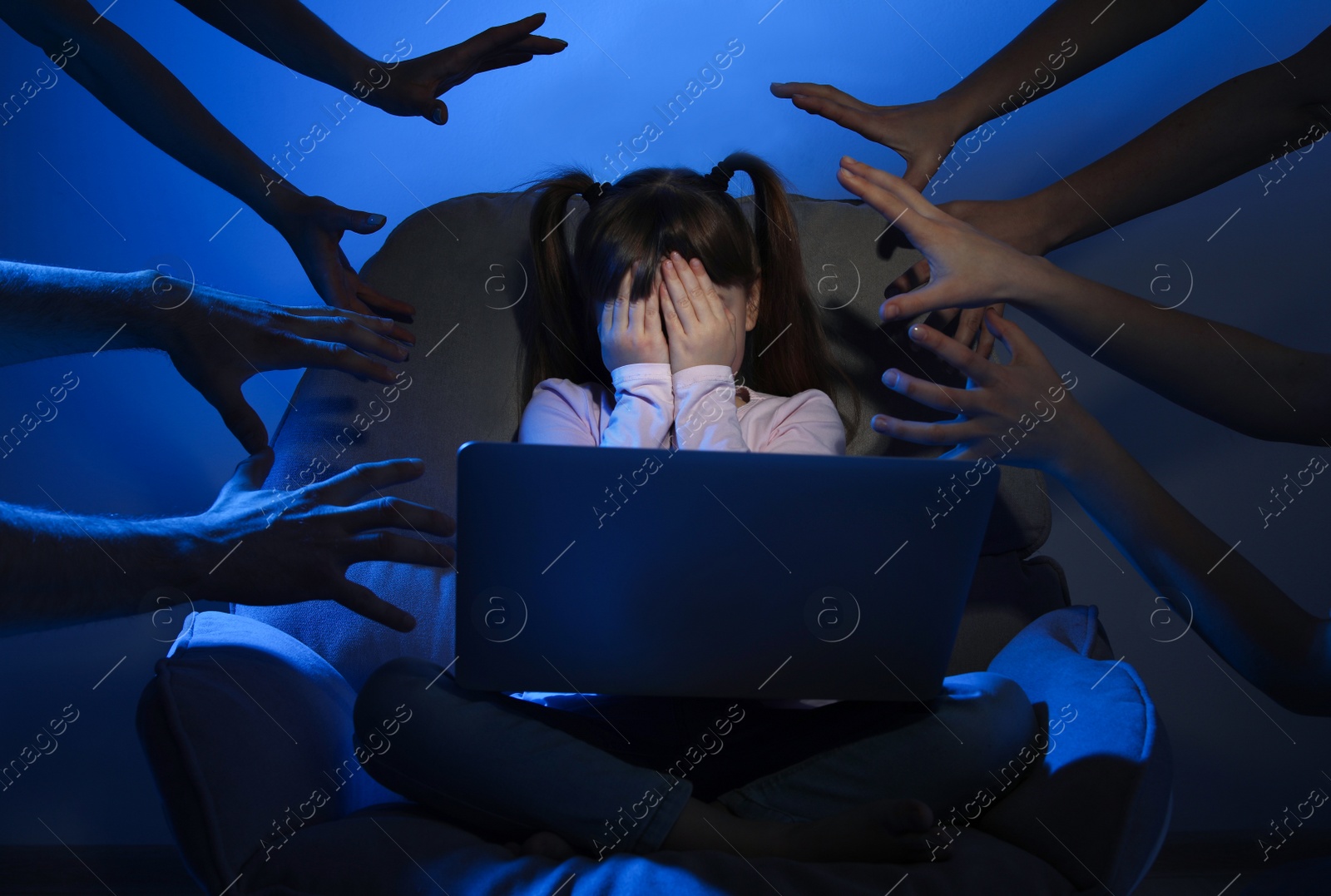 Photo of Strangers reaching frightened little child with laptop on color background. Cyber danger