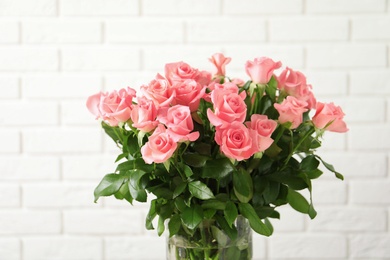 Photo of Vase with beautiful rose flowers on blurred background