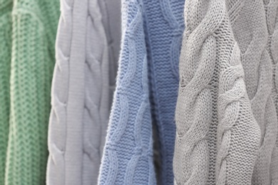 Collection of warm sweaters as background, closeup