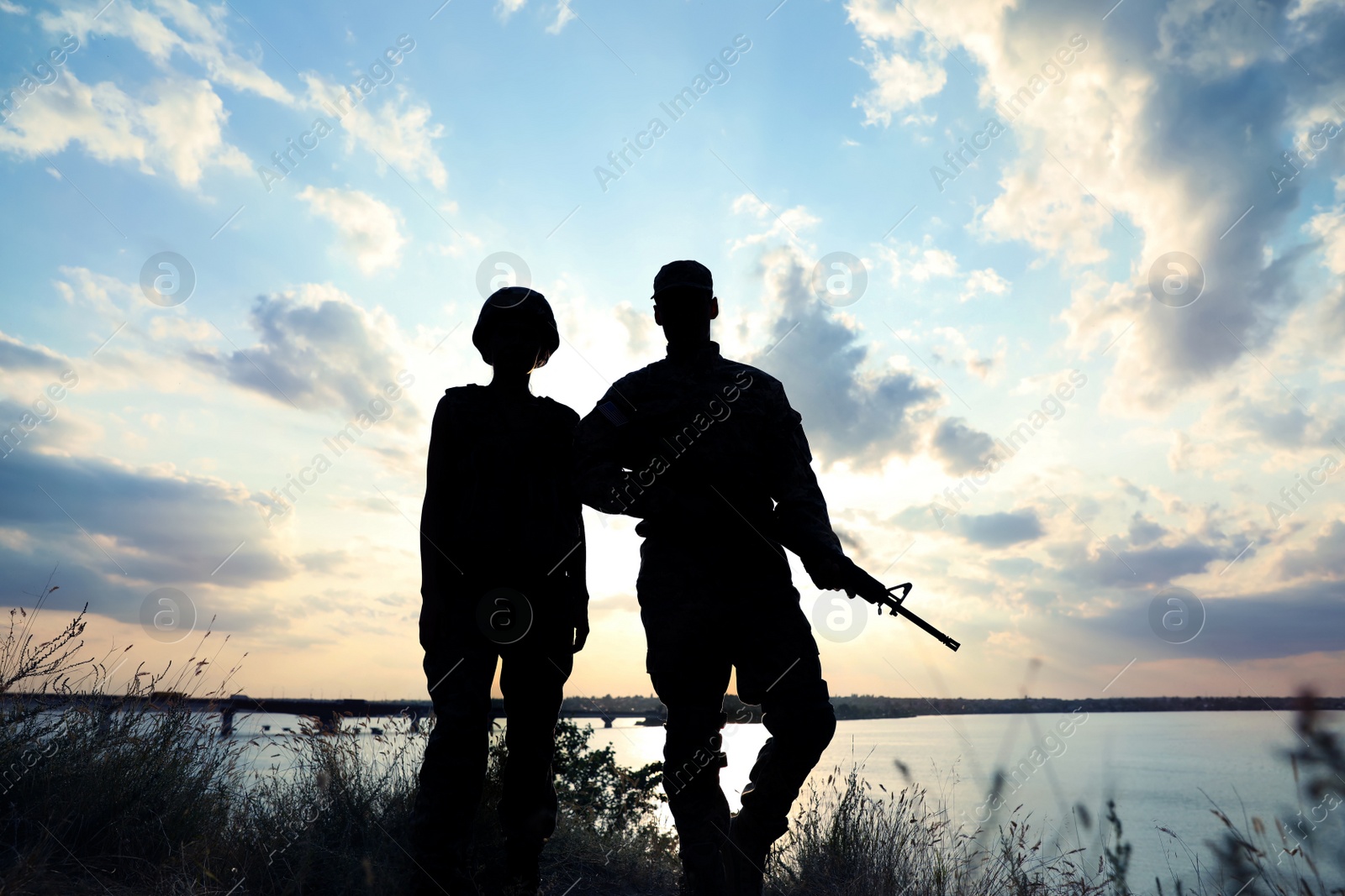 Photo of Soldiers in uniform patrolling outdoors. Military service