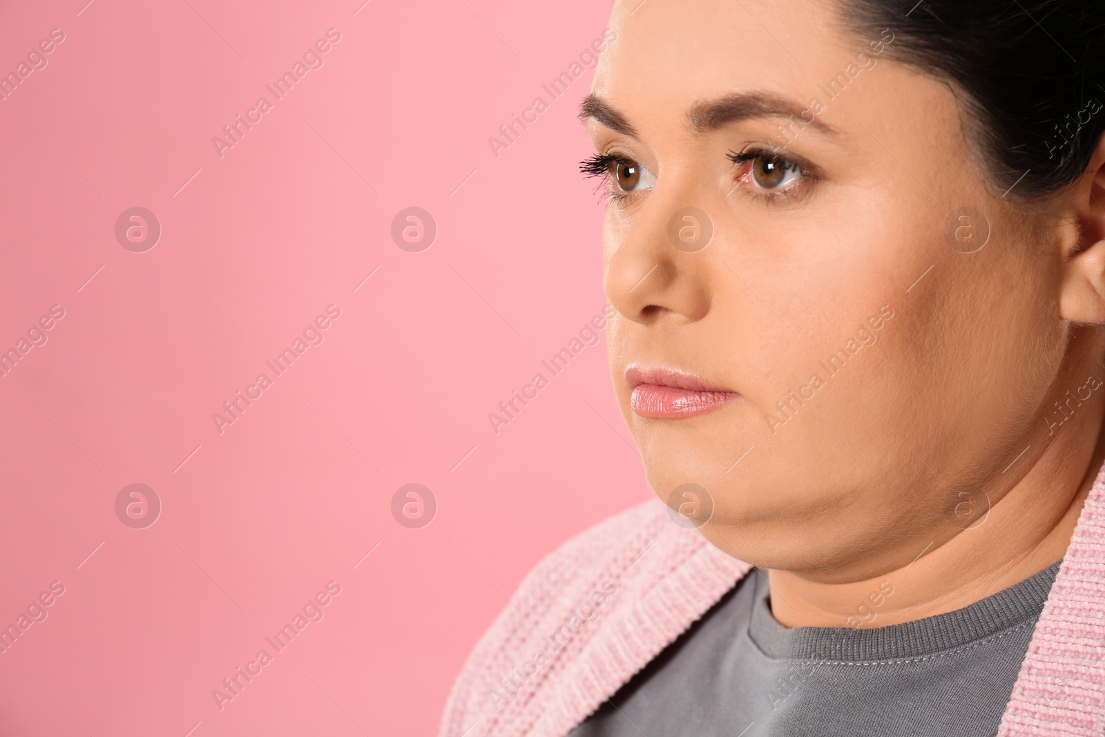 Photo of Woman with double chin on pink background. Space for text