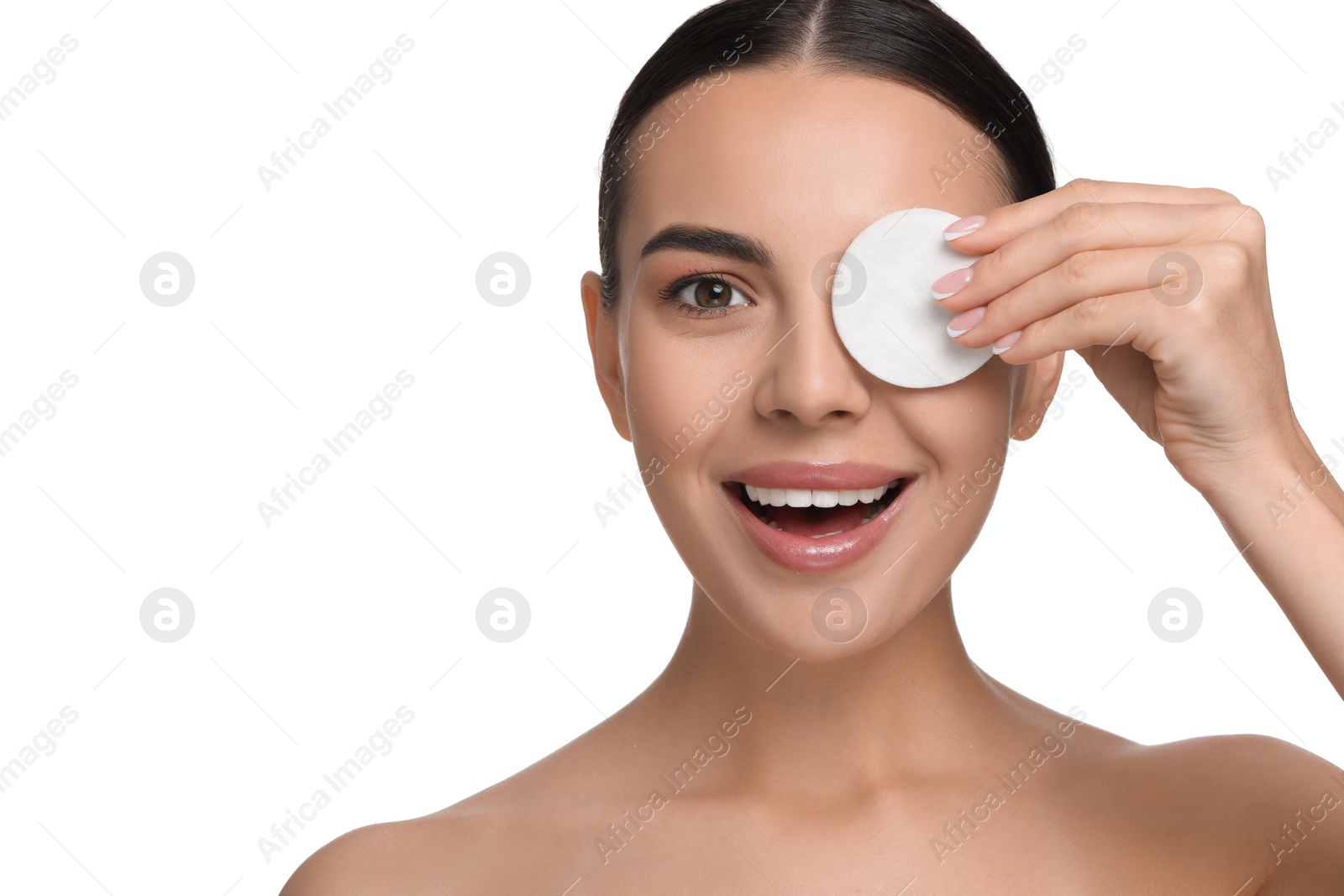 Photo of Beautiful woman removing makeup with cotton pad on white background