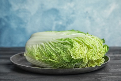 Photo of Plate with fresh ripe cabbage on table