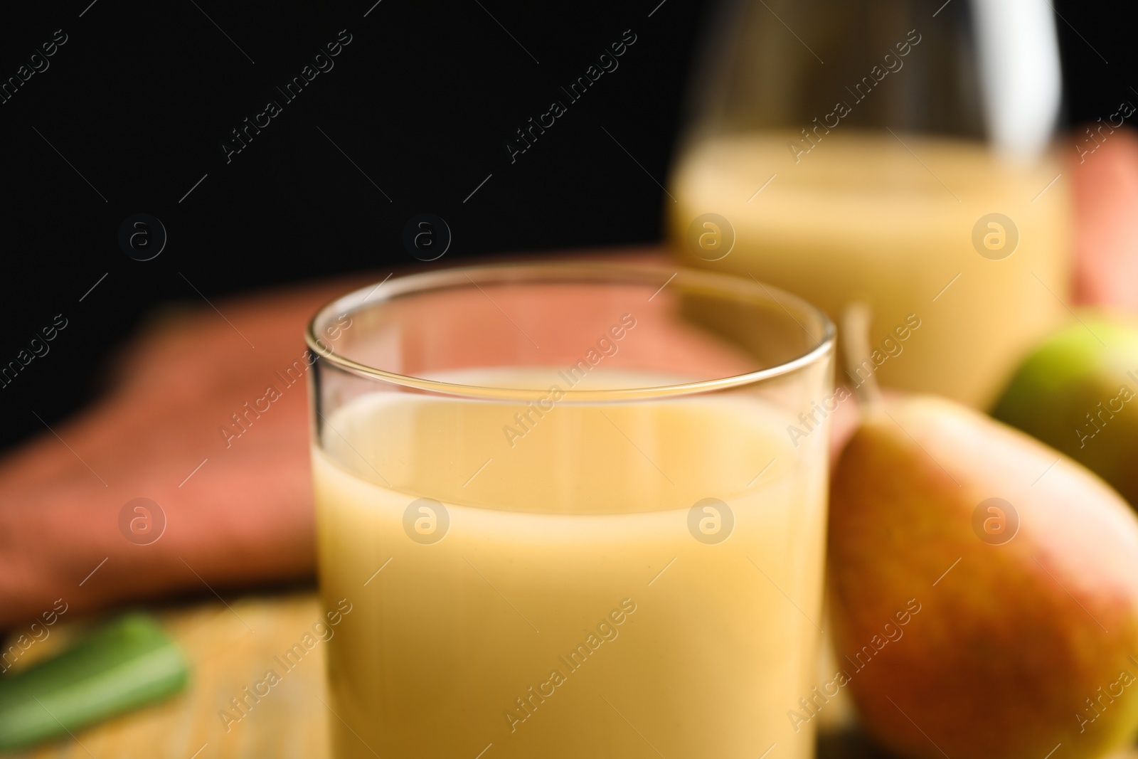 Photo of Fresh pear juice in glass, closeup view