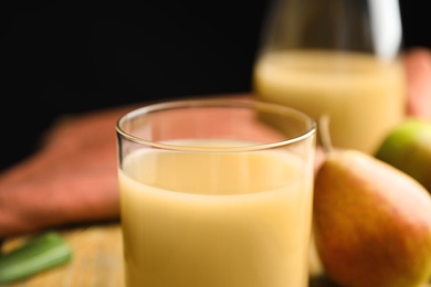 Photo of Fresh pear juice in glass, closeup view