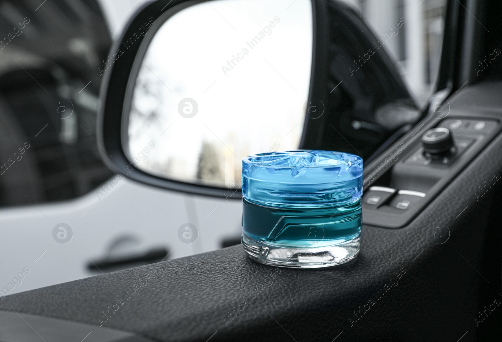 Photo of Stylish air freshener inside of car. Space for text