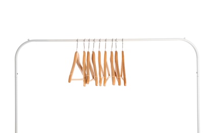 Photo of Wardrobe rack with wooden hangers isolated on white