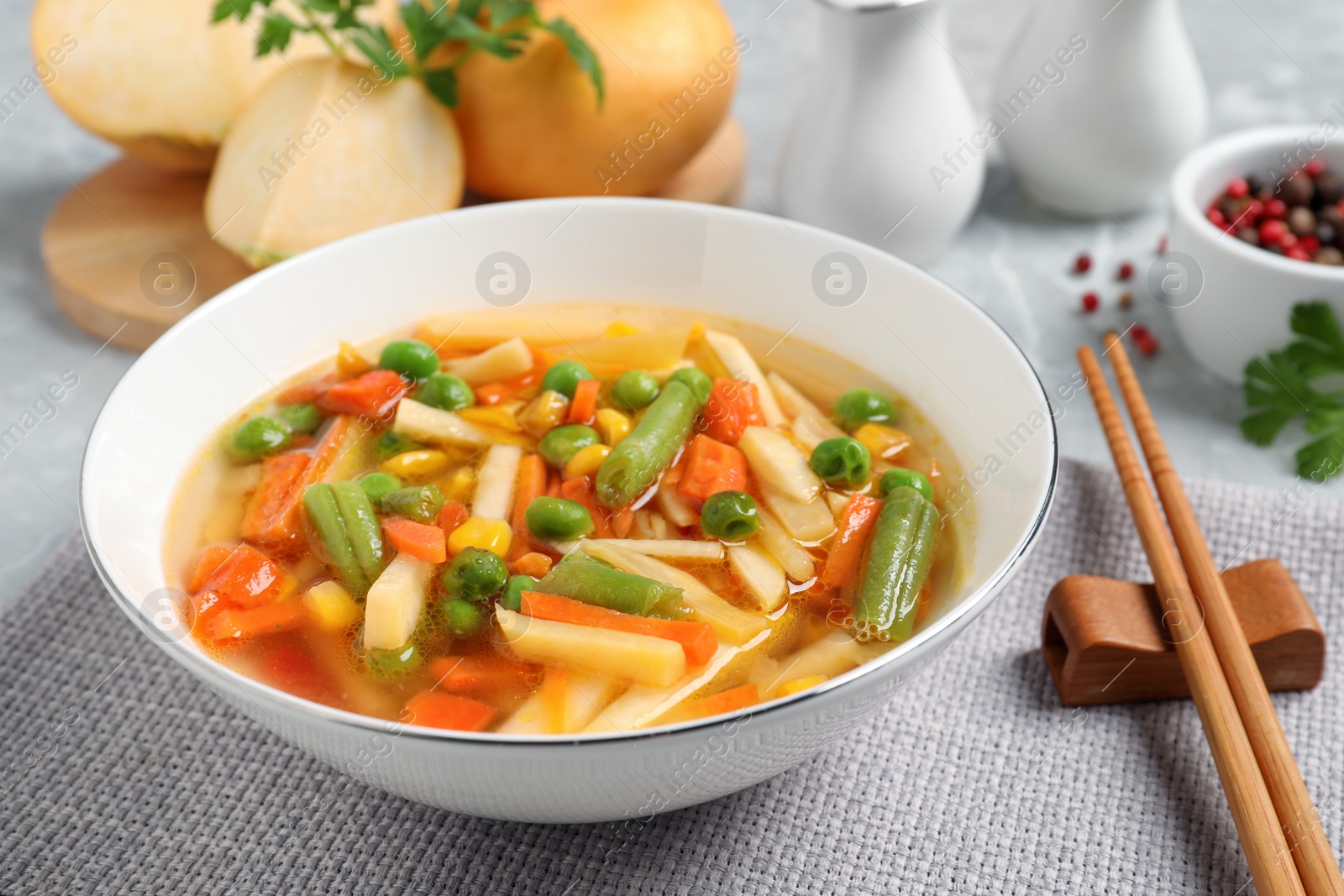 Photo of Bowl of delicious turnip soup on table