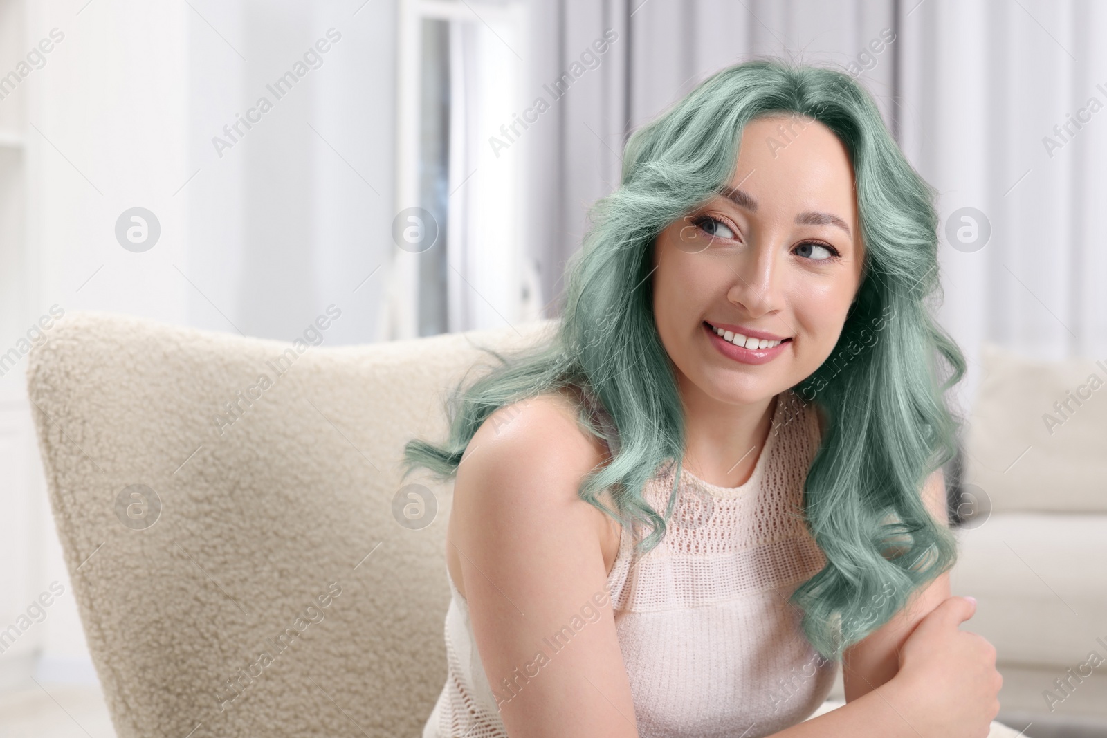 Image of Trendy hairstyle. Young woman with colorful dyed hair at home. Space for text