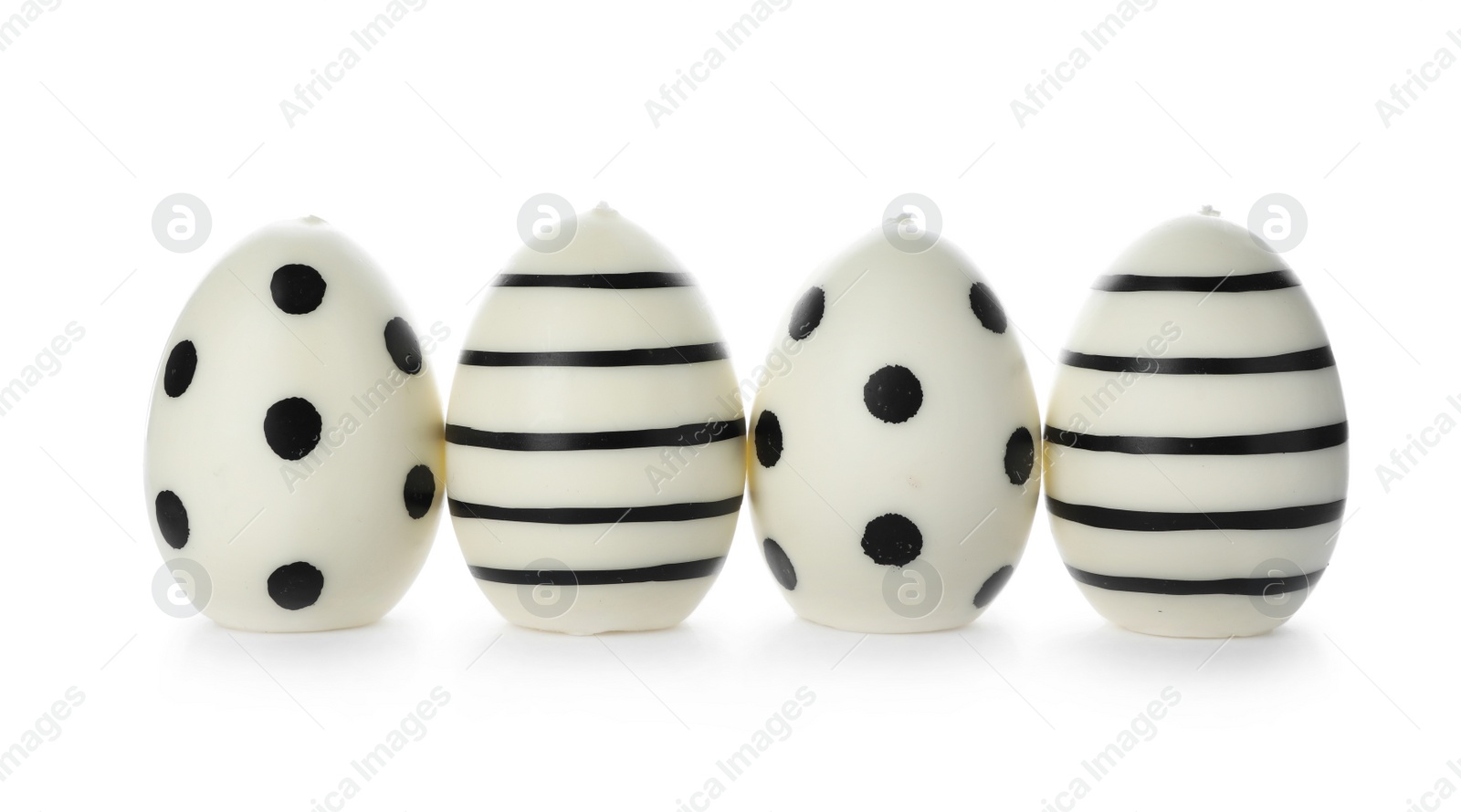 Photo of Line of traditional Easter eggs decorated with black paint on white background