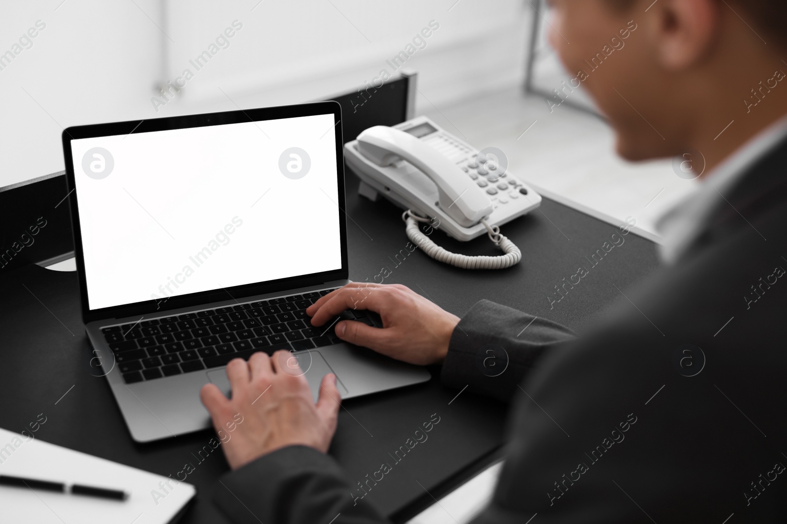 Photo of Man watching webinar at table in office, closeup