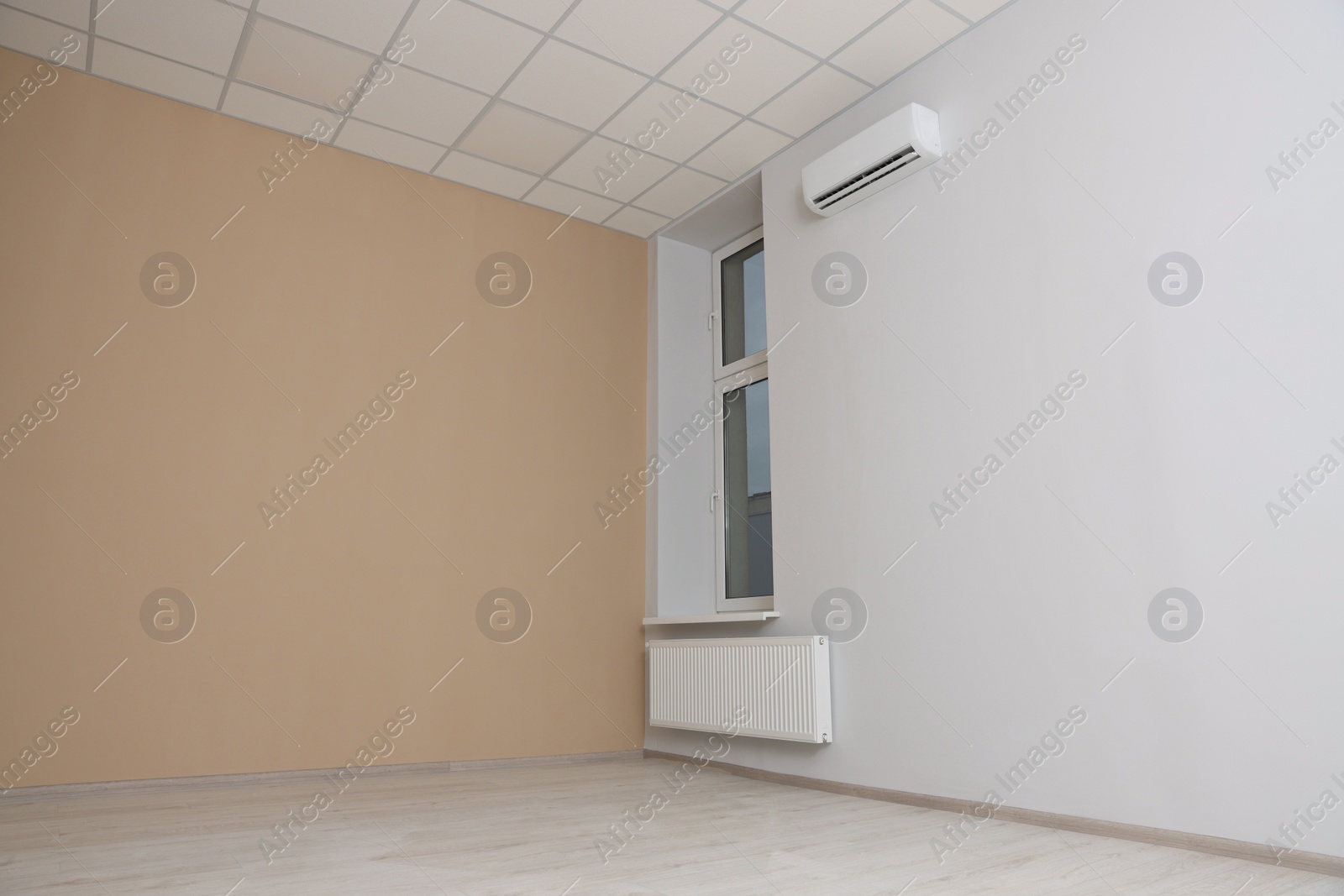 Photo of New empty office room with clean window and beige wall