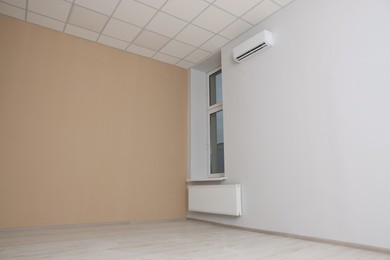 Photo of New empty office room with clean window and beige wall